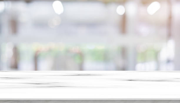 istock Abstract blurred modern interior office room background with perspective cement quartz table for show, promote and design content or product on display concept 1833146659