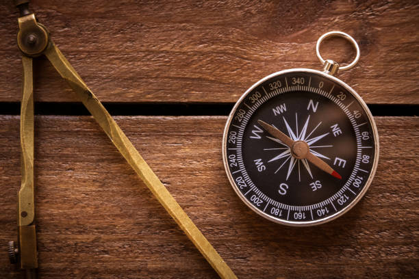 istock Vintage drawing and navigational Compass on a rustic wooden board 1833148610