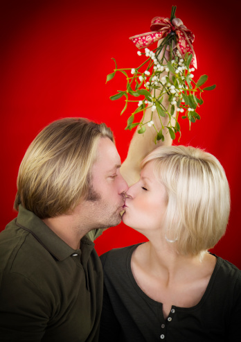 Couple tries to kiss under the mistletoe