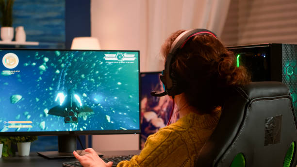 istock Joyful player celebrates victory winning space shooter video game 1833166808