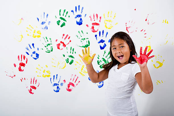 istock Young Hispanic Asian girl playing with finger paints 183316682