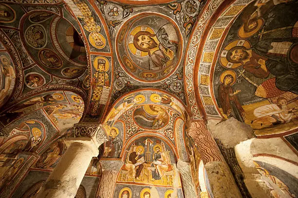 "The image of Christ, looking down from a ceiling. This is a church, carved from rock in a cave in the Cappadocia region of Turkey."