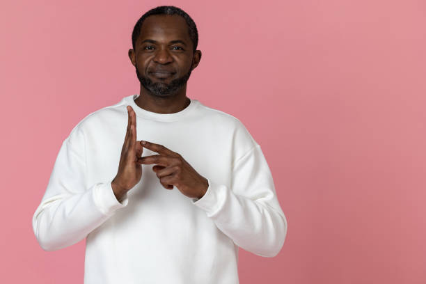 istock Deaf mute black man wearing white sweatshirt gesturing sign language 1833172535