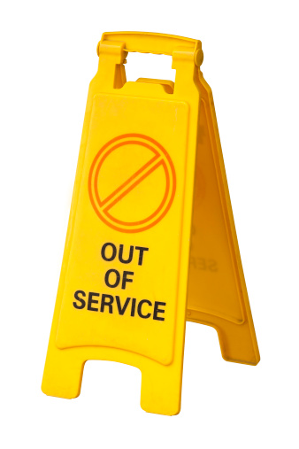 Yellow plastic Out Of Service sign isolated on white. Includes clipping path.