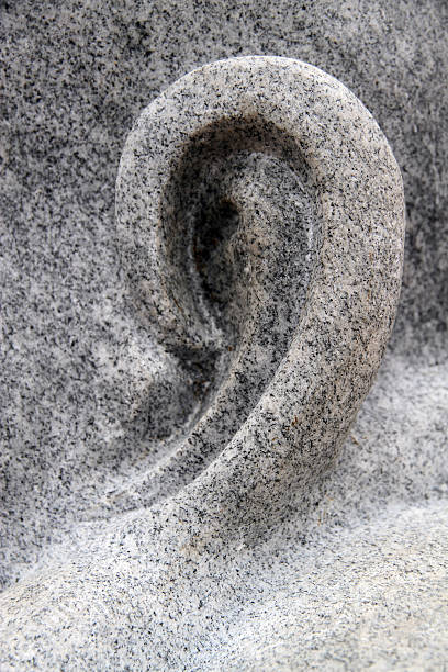 A detail of a sculpture of the Buddha.
