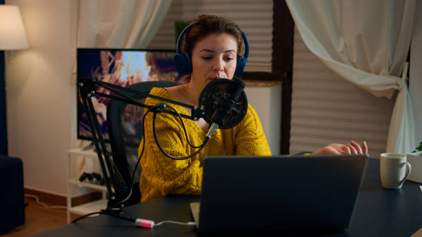 istock Vlogger on air during online show using laptop 1833184535