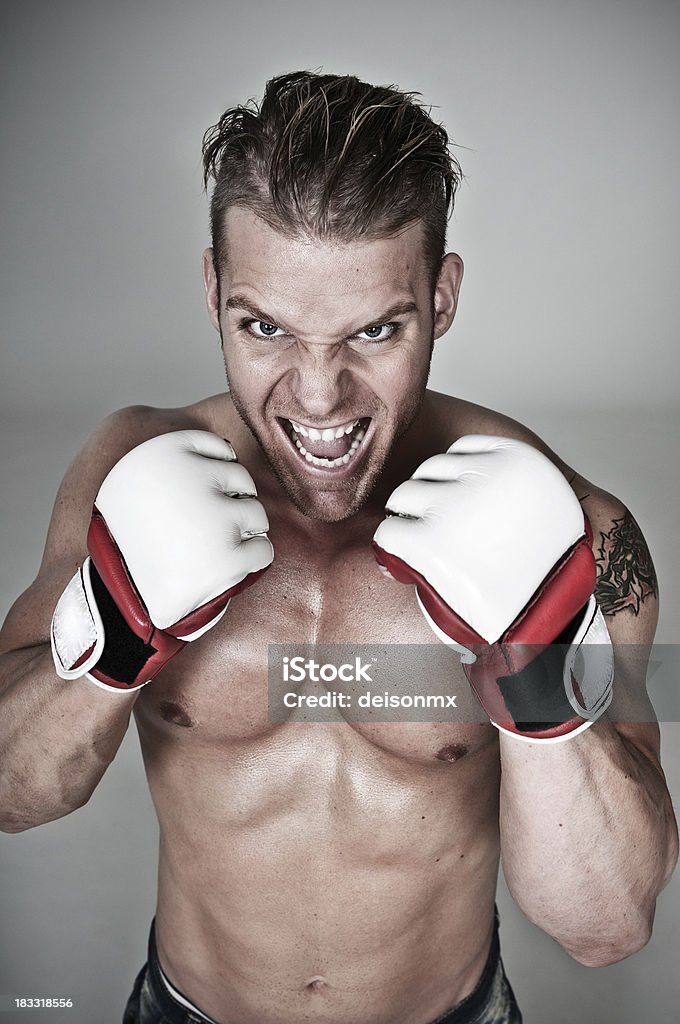 Aggressive fighter Muscular boxer ready to pick up a fight! Anger Stock Photo