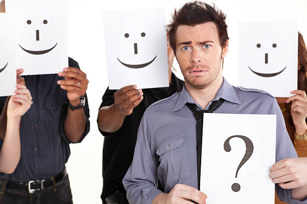istock Young Man With Question Mark Sign Among Happy People 183318764