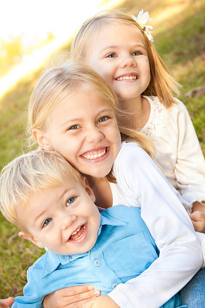 istock Cute Sibling Children Sitting Together Giving Hugs 183319207