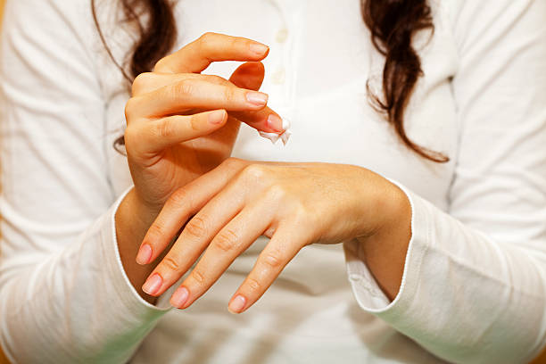istock Female applying hand cream on her left hand 183319359
