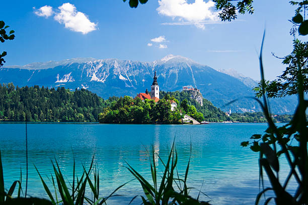 lake bled series, slovenia, world-known beautiful scenery of the small island with chuch in the middle of the lake, bled castle in the background