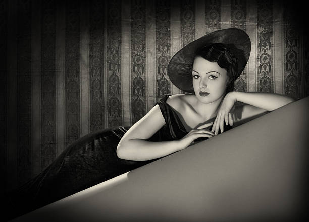 Beauty with the hat in film noir style. Emulations of vintage style photography.See the Lightbox femme fatale stock pictures, royalty-free photos & images