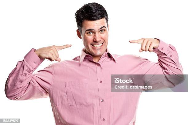 Portrait Of Young Man Pointing Face With Two Fingers Stock Photo - Download Image Now