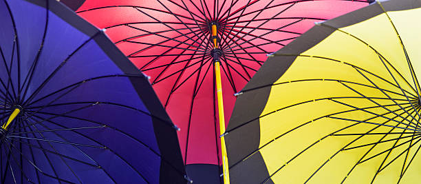 Three multicolored textile umbrellas.