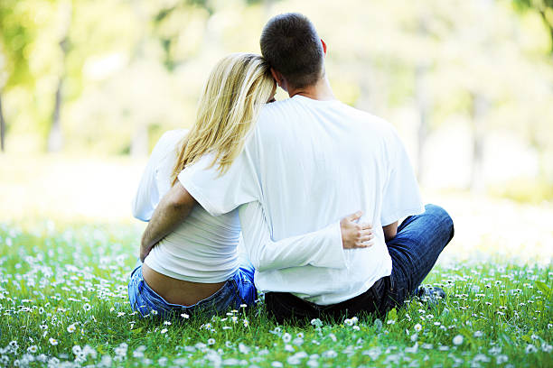 Nature is the perfect place to fall in love. Couple lying on grass.
