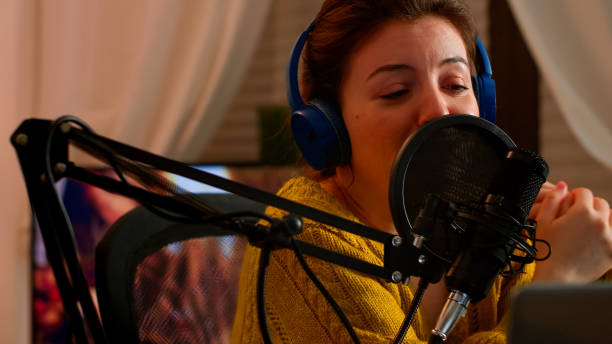 istock Close up of professional influencer making podcast from home studio 1833198801