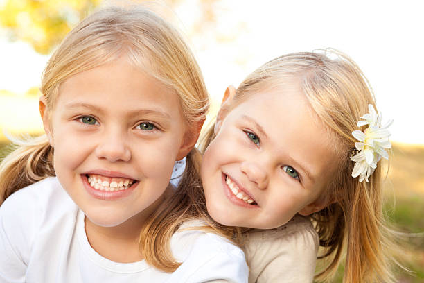 istock Two Young Sisters Happy Together Outside 183320218