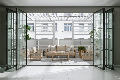Entrance Of Balcony With Sofa, Armchairs, Coffee Table And Potted Plants