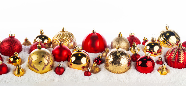 nine colorful christmas baubles in a row, isolated on white background. 