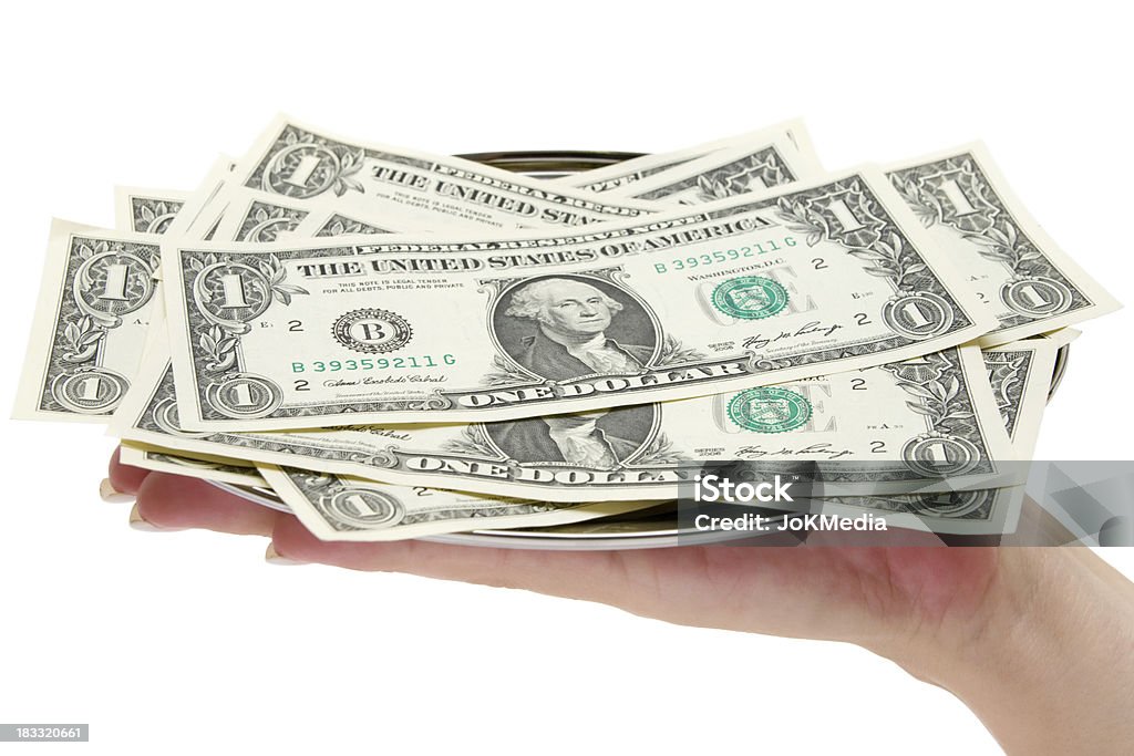 Serving Money Human hand holding a serving tray full of dollar banknotes. Isolated on a white background. Selective focus. Abundance Stock Photo