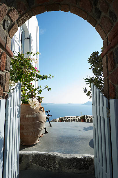 istock Arched Doorway Looks Out Over Greek Islands 183321020