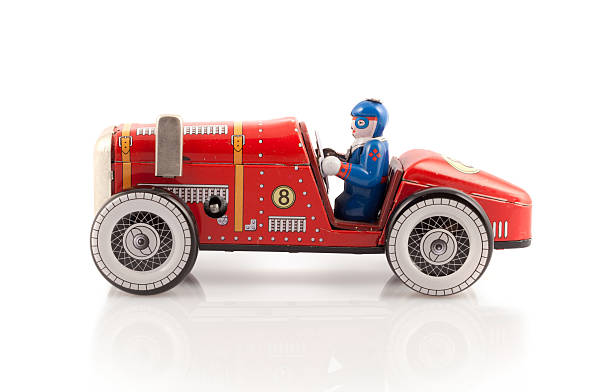 Red metal toy car with driver stock photo