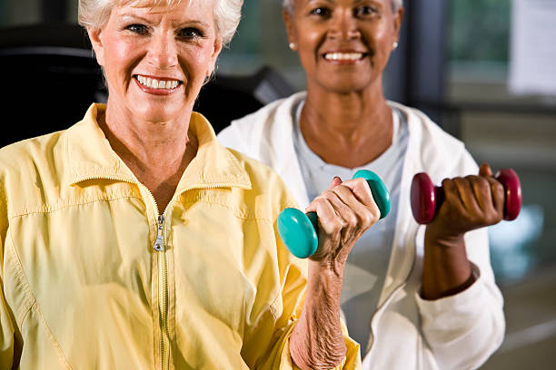 istock Multiracial senior women exercising, lifting handweights 183321074