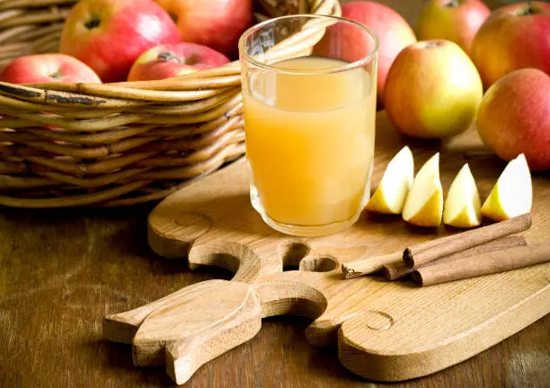 "Close up of juice, apples and cinnamon sticks, very shallow DOF.FOODS"