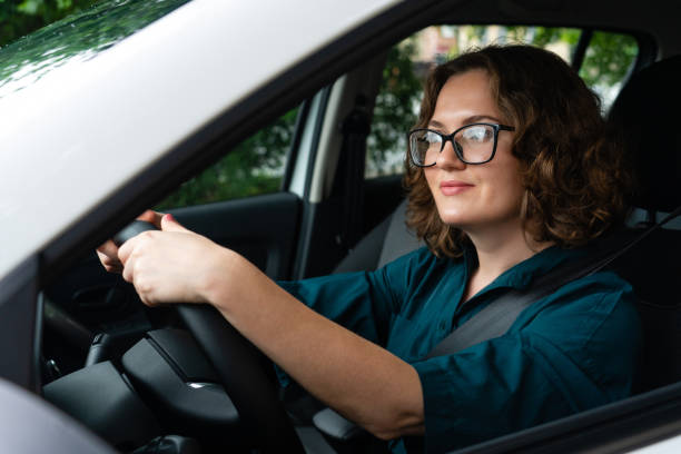 istock Woman driver is sitting in the car. 1833212158