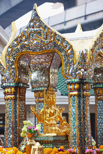 The Erawan Shrine sits in the heart of the city of Bangkok at Ratchaprasong intersection. It was originally built in 1956 to counter bad luck besetting the original adjacent Erawan Hotel. This four-faced Brahma and Hindu statue was designed and made by the Department of Fine Arts and enshrined on November 9th of that year. The original Erawan Hotel was later demolished in 1987 and the land then used for the location of the subsequently built Grand Hyatt Eawan Hotel. The original Erawan Shrine statue was attacked and demolished in March 2006 by a man believed to be mentally challenged. The statue was replaced within three months by a newer statue, made of plaster, precious metals and fragments from the original statue. This famous public shrine continues today to attract many local and foreigners visitors, who pay respect and adorn the Shrine with flowers, garland and burning incense. Classical Thai dance perfomances are also perfomed thoughout each day at this famous city attraction.