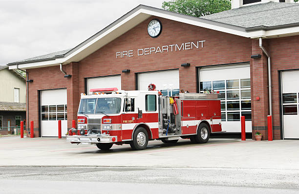 fire truck fire truck in front of fire station fire station stock pictures, royalty-free photos & images