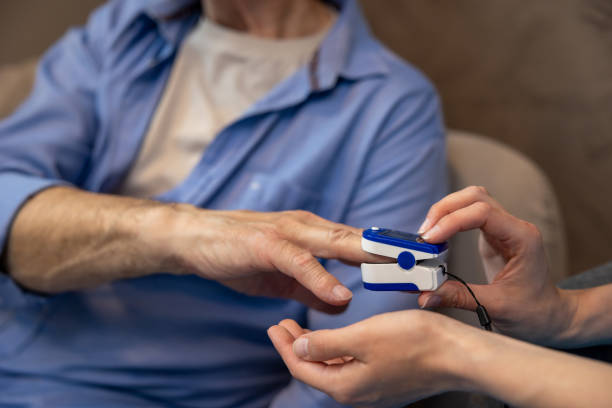 istock Nurse checking pulse or level of oxygen using oximeter of unrecognizable senior man. 1833226576