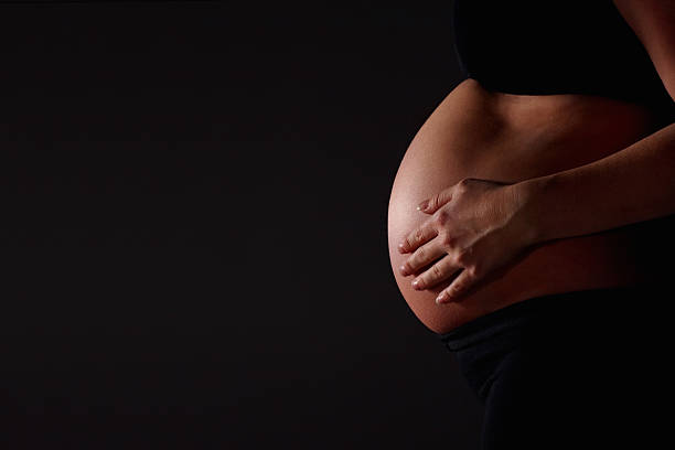 istock Pregnant woman feeling her stomach 183322765