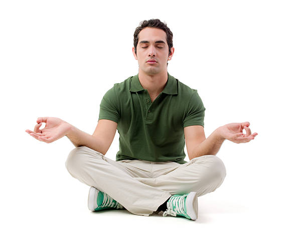 Young man practicing yoga "Young man practicing yoga , lotus position" cross legged photos stock pictures, royalty-free photos & images