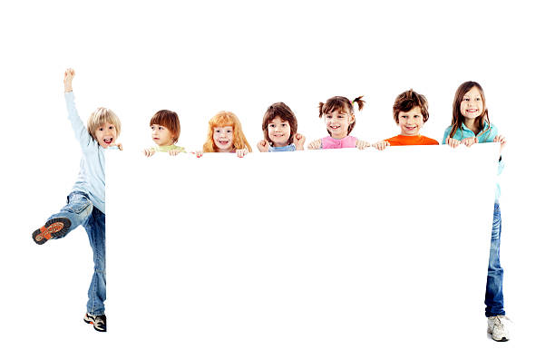 istock Happy children are holing a big blank paper. 183324178