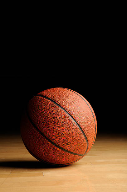 istock Basketball with shadow on wooden floor 183325111