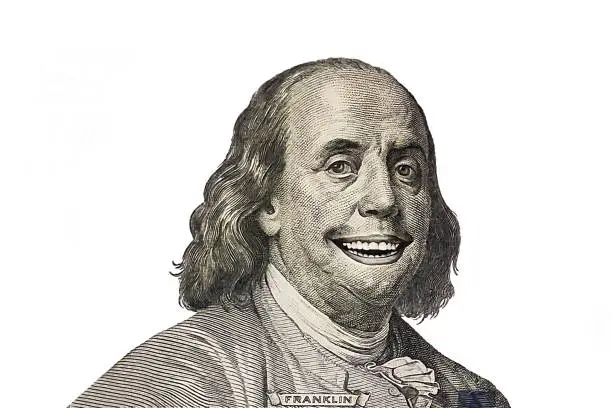 Benjamin Franklin smiling portrait cut from new 100 dollar banknote on white background