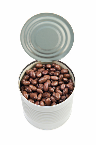 Open can of black beans isolated on white. More cans...