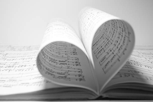 Music Love Sheet music bending into a heart shape. sheet music heart stock pictures, royalty-free photos & images