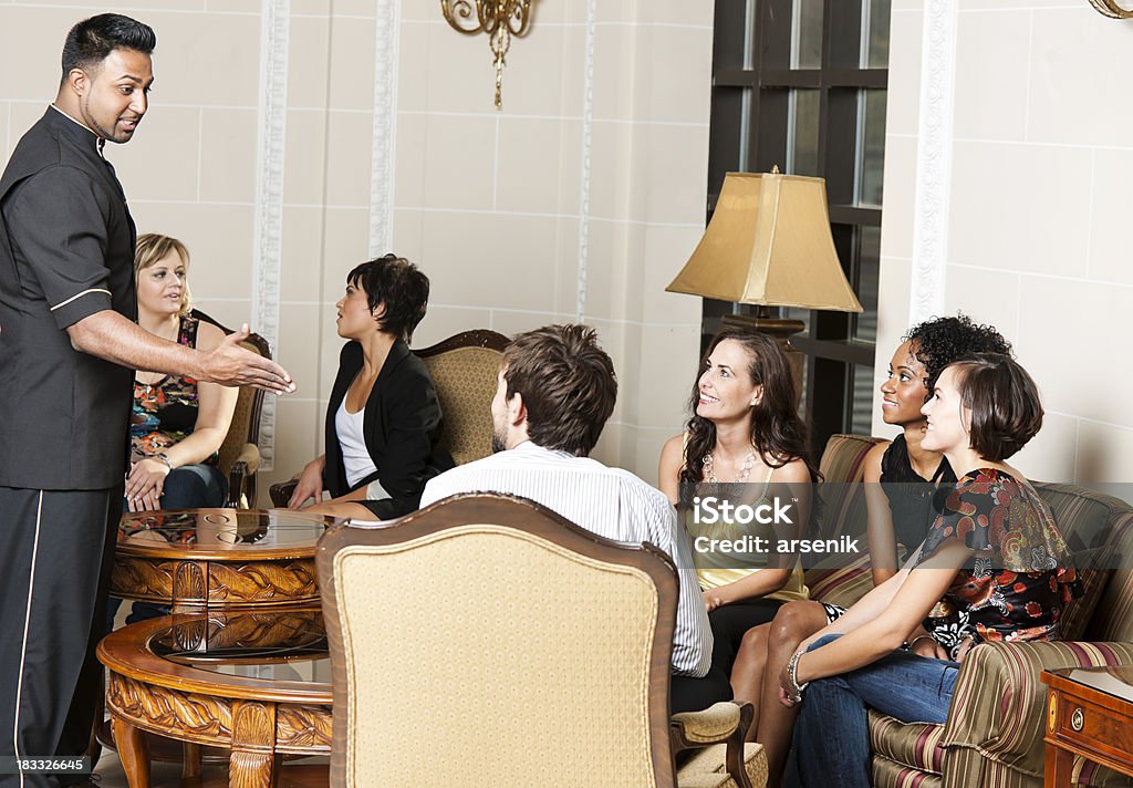 Friends in hotel lobby Group of friends sitting in a hotel lobby. 20-29 Years Stock Photo