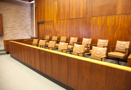 A courtroom jury box of 12 jury seats with room for 1 alternate.