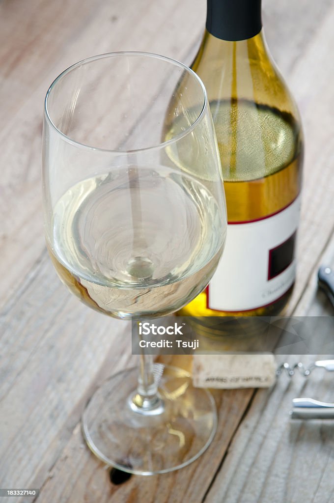 Glass of white wine Glass of white wine and bottle.More food images: Chardonnay Grape Stock Photo