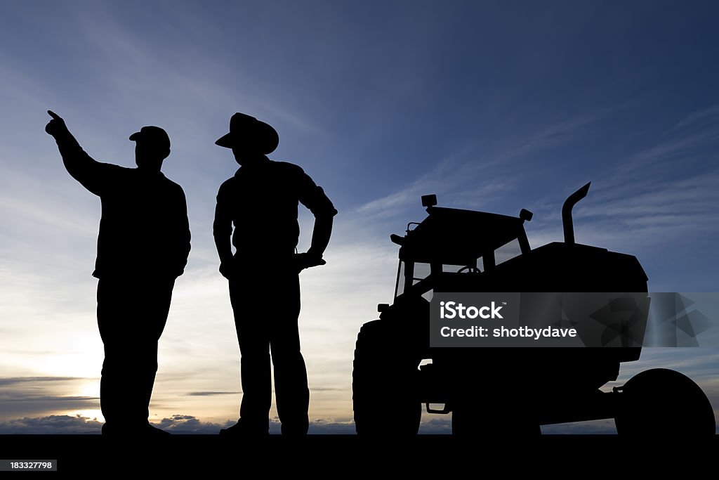 Farmers at Dusk A royalty free image from the agricultural industry depicting two farmers in conversation silhouetted at dusk. Farmer Stock Photo