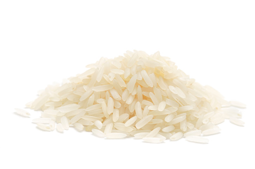 Fragrant Jasmine Rice in a heap isolated on a white background.