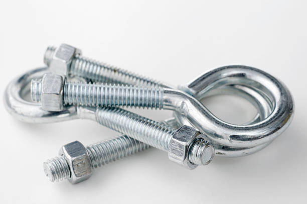 pile of eye bolts with nuts -- focus on foreground nut
