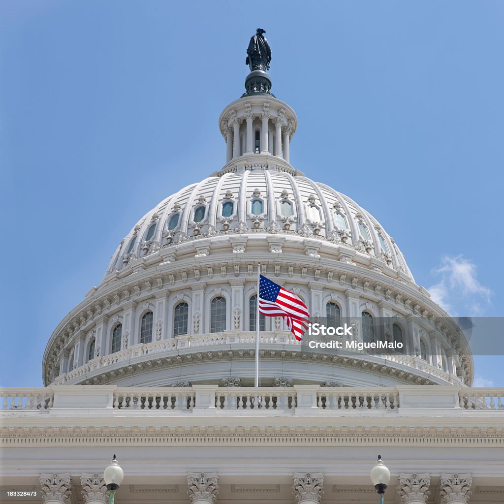 US Capitol US Capitol Building in Washington DC  with American Flag Waving on a Beautiful Shiny Summer Day American Flag Stock Photo
