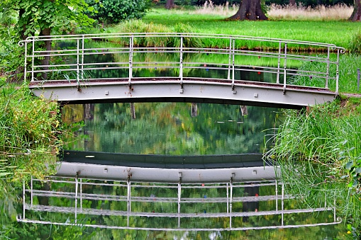 Small bridge reflecting in water