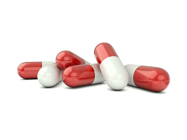 vermelho e branco cápsulas - antibiotic red medicine healthcare and medicine imagens e fotografias de stock