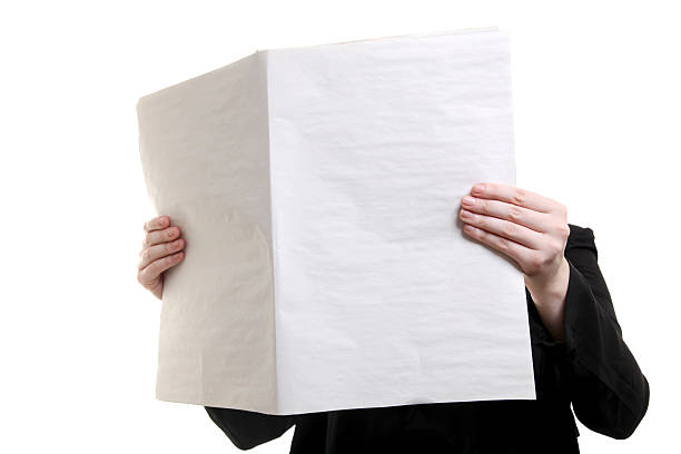 istock Individual holding blank newspaper in front of their face 183329337