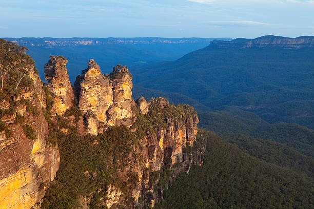 The Three Sisters rock formation in the Blue Mountains, New South Wales, Australia. Shot at sunset with the beautiful late evening sun reflecting on the rock formation.